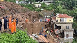 Members of rescue teams look for survivors amidst the debris next to a stone quarry that collapsed following torrential rains brought by cyclone Remal on the outskirts of Aizawl, the capital of northeastern state of Mizoram