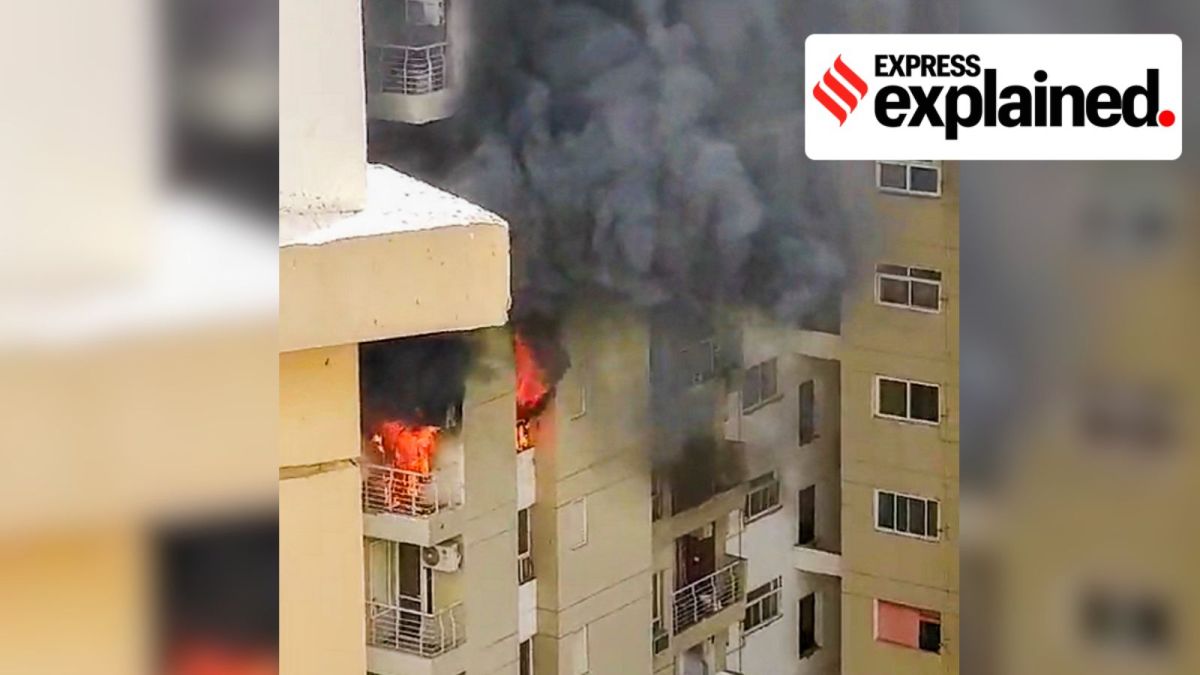 Smoke billows out after a fire broke out in the Lotus Boulevard Society at Sector 100 in Noida, Thursday, May 30, 2024.