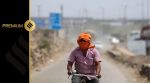 A man rides his cycle near a landfill site on a hot summer day during a heatwave in New Delhi, India, May 27, 2024. REUTERS