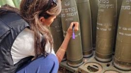 This photo provided by the Office of Israeli lawmaker Danny Danon, shows former U.S Ambassador to the United Nations, Nikki Haley signing an Israeli artillery shell while touring Israel’s northern border with Lebanon on Tuesday, May 28, 2024. Haley's visit comes as Israel faces heightened criticism for not doing enough to protect civilians in Gaza amid its war against Hamas, and days after Israeli airstrikes triggered a fire in a camp for displaced Palestinians that appeared to be one of the war’s deadliest attacks. (Office of Israeli lawmaker Danny Danon via AP)