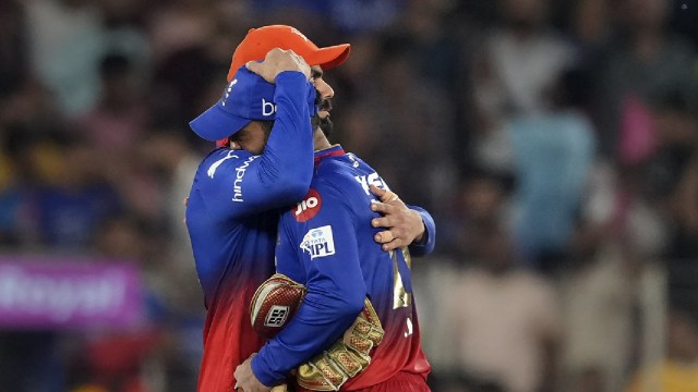 RCB's Virat Kohli and Dinesh Karthik after the Indian Premier League (IPL) 2024 T20 cricket match between Royal Challengers Bangaluru and Rajasthan Royals, at the Narendra Modi Stadium, in Ahmedabad, Wednesday, May 22, 2024. Rajasthan Royals won the match by 4 wickets. (PTI Photo)