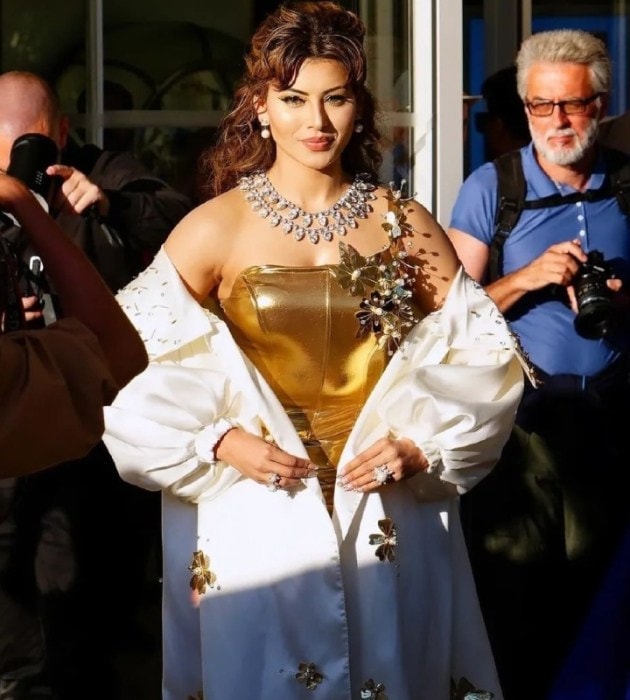 After mesmerising everyone with a variety of looks, Urvashi Rautela made heads turn in her new look at Cannes 2024. She looked gorgeous in a golden metallic gown accompanied with a white cape.