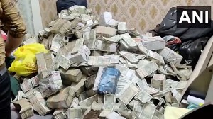 Videos and photos shared by the sources showed officials of the central probe agency taking out wads of currency notes from large bags in a room. (Screengrab: ANI)