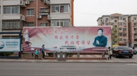 A faded propaganda poster depicting President Xi Jinping with the slogan 'People have faith, the country has power, there is hope for the nation' in Zhangjiawan, a suburb of Beijing, April 3, 2024.(Gilles Sabri/The New York Times)