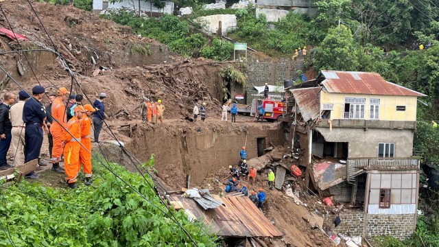 Members of rescue teams look for survivors amidst the debris next to a stone quarry that collapsed following torrential rains brought by cyclone Remal on the outskirts of Aizawl, the capital of northeastern state of Mizoram, India, May 28, 2024. REUTERS