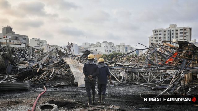 Firefighters carry on with cooling operations and search for remains at TRP game zone, Rajkot on Sunday morning.