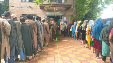 Voters queue at Lassipora in Pulwama district during phase 4 of Lok Sabha elections. (Express photo by Shuaib Masoodi)