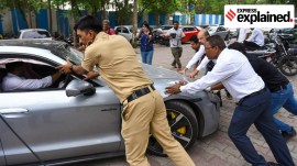 A technical team from Porsche checking the car involved in the Pune crash.