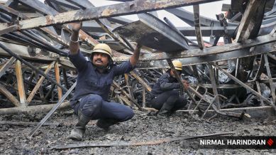 Firefighters carry on with cooling operations and search for remains at TRP game zone, Rajkot on Sunday morning.