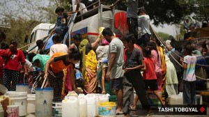 Delhi News Live Updates: Residents of the Vivekananda camp fill water from a tanker