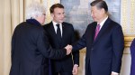 French filmmaker Jean-Jacques Annaud shakes hands with Chinese President Xi Jinping flanked by France's President Emmanuel Macron in Paris.