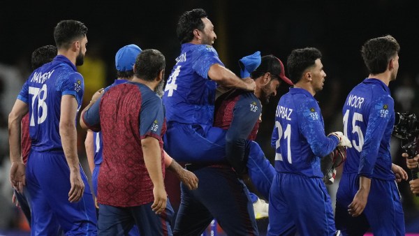 Afghanistan players celebrate after defeating Australia by 21 runs in their men's T20 World Cup cricket match at Arnos Vale Ground, Kingstown, Saint Vincent and the Grenadines, Saturday, June 22, 2024. (AP Photo)