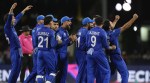 Afghanistan players celebrate the dismissal of Australia's Tim David during the men's T20 World Cup cricket match between Afghanistan and Australia at Arnos Vale Ground, Kingstown, Saint Vincent and the Grenadines, Saturday, June 22, 2024. (AP Photo)
