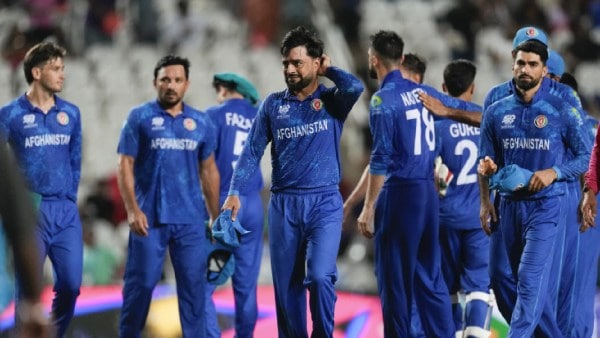 Afghanistan's captain Rashid Khan, centre, walks from the field with his players following their nine wicket loss to South Africa in their men's T20 World Cup semifinal cricket match at the Brian Lara Cricket Academy in Tarouba, Trinidad and Tabago, Wednesday, June 26, 2024. (AP Photo)