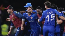 Afghanistan players celebrate after defeating Australia by 21 runs in their men's T20 World Cup cricket match at Arnos Vale Ground, Kingstown, Saint Vincent and the Grenadines. (AP)