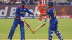 Nepal's Anil Kumar Sah, left, and captain Rohit Paudel bumps gloves between overs during an ICC Men's T20 World Cup cricket match against the Netherlands at Grand Prairie Stadium in Grand Prairie, Texas