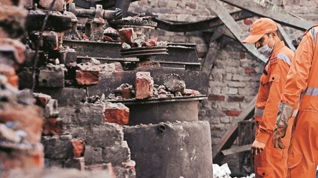 Fire personnel at the site of Alipur blaze, Delhi, in February. (Express Archive)