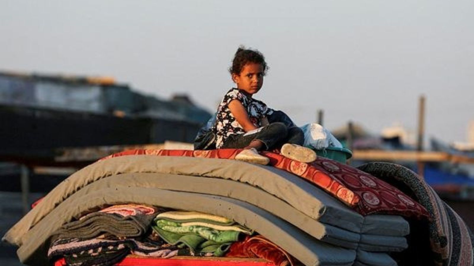 Palestinian sits on top of belongings as he flees Rafah due to an Israeli military operation, amid the Israel-Hamas conflict, in Rafah, in the southern Gaza Strip (Reuters Photo)