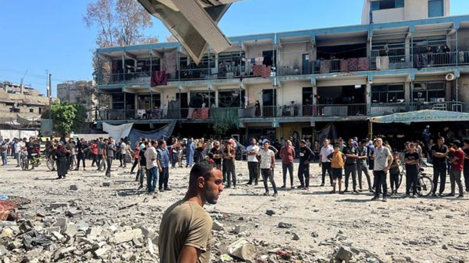 Palestinians inspect the site of an Israeli strike on a UNRWA school sheltering displaced people, amid the Israel-Hamas conflict, in Nuseirat refugee camp in the central Gaza Strip, June 6, 2024. 