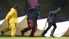 IND vs BAN Weather Update: Ground staff run onto the field with covers as rain delays play during the ICC Men's T20 World Cup cricket match between Australia and Bangladesh in North Sound, Antigua and Barbuda. (AP)