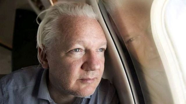 WikiLeaks founder Julian Assange looks out a plane window as he approaches Bangkok airport for layover, according to the post by Wikileaks on X, in this picture released to social media