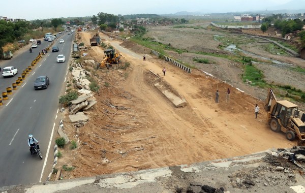Work in progress of damaged bridge during last year flood at Kaushalya River in Pinjore. (Express Photo by Kamleshwar Singh)