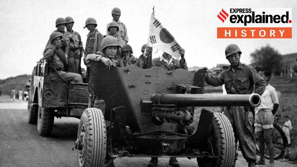 A group of men transporting a 37-mm anti-tank gun by a weapons carrier