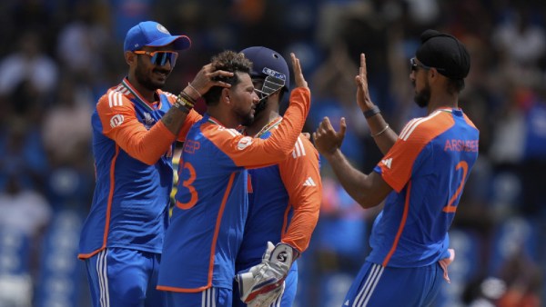 India's Kuldeep Yadav is congratulated by teammates after taking the wicket of Australia's Glenn Maxwell during an ICC Men's T20 World Cup cricket match at Darren Sammy National Cricket Stadium in Gros Islet, Saint Lucia,