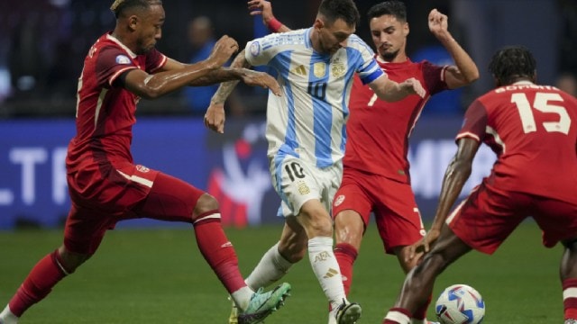 Argentina's Lionel Messi, center, and Canada's Stephen Eustaquio battle for the ball during a Copa America Group A soccer match in Atlanta, Thursday, June 20, 2024. (AP Photo)