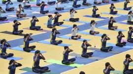 Youths perform yoga as they rehearse ahead of International Yoga Day Celebration at Kalinga Stadium in Bhubaneswar. (Reuters)