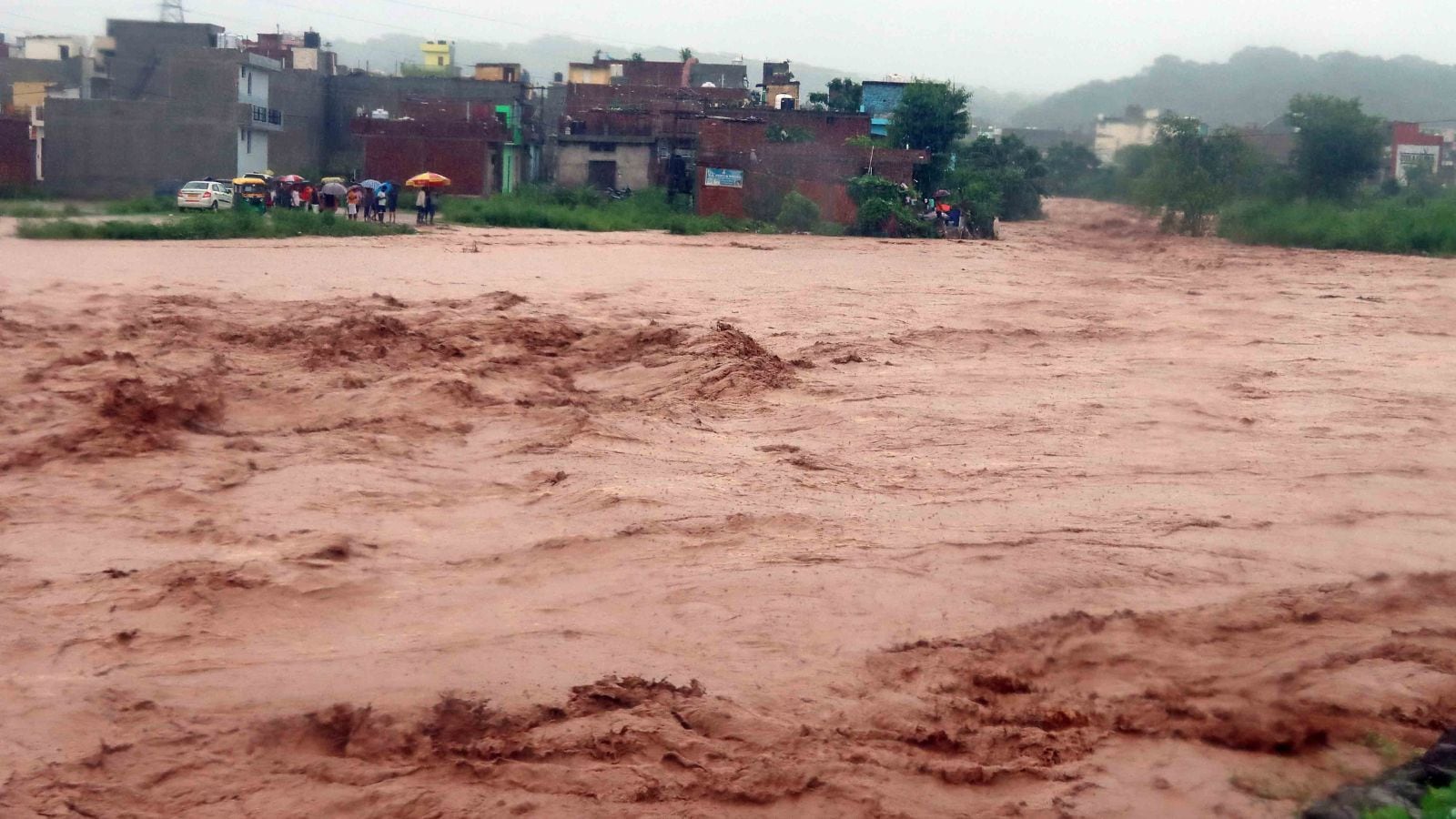 Overflowing Patiala Ki Rao in Nayagaon near Chandigarh; and, a portion of a road caved in, in New Chandigarh, Mullanppur, after heavy rainfall last year. Archive
