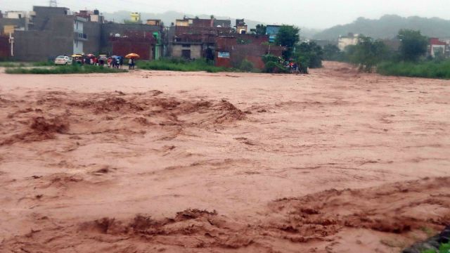Overflowing Patiala Ki Rao in Nayagaon near Chandigarh; and, a portion of a road caved in, in New Chandigarh, Mullanppur, after heavy rainfall last year. Archive