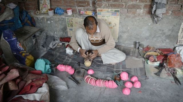 A worker makes leather cricket balls at the Bootan Mandi area under the Jalandhar West (Reserved) Assembly segment. Over the past few decades, the hides business declined sharply by 80-90 per cent. (Express photo)