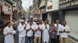 Congress leaders Jignesh Mevani (fourth from left) and Lalji Desai (third from right) appeal people to keep their shops shut, in Rajkot on Tuesday. Express photo