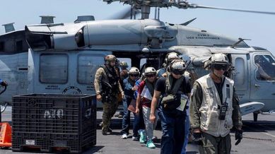 Sailors from the Dwight D. Eisenhower Carrier US Navy Strike Group assist distressed mariners rescued from the Liberian-flagged, Greek-owned bulk carrier M/V Tutor that was attacked by Houthis, in the Red Sea, June 15, 2024.