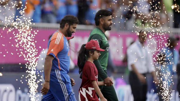 Pakistan's captain Babar Azam, right, and India's captain Rohit Sharma walk into the field before the start of the ICC Men's T20 World Cup cricket match between India and Pakistan at the Nassau County International Cricket Stadium in Westbury, New York