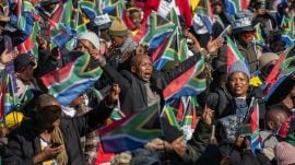 People wave the flag of South Africa in celebration during the inauguration of President Cyril Ramaphosa to a second term in Pretoria on Wednesday, June 19, 2024.