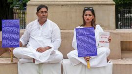 Newly elected TMC MLAs Rayat Hossain Sarkar and Sayantika Banerjee wait for the second consecutive day on the West Bengal Legislative Assembly premises for their swearing-in ceremony, in Kolkata, Thursday,