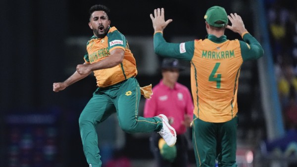 South Africa's Tabraiz Shamsi celebrates with teammate Aiden Markram after taking the wicket West Indies' Sherfane Rutherford during the ICC Men's T20 World Cup cricket match between the West Indies and South Africa at Sir Vivian Richards Stadium in North Sound, Antigua and Barbuda