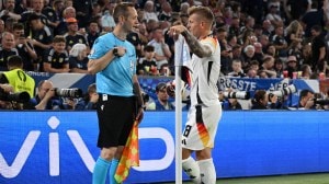 Germany's Toni Kroos speaks with assistant referee Benjamin Pages during a VAR referral after Germany's Ilkay Gundogan was fouled by Scotland's Ryan Porteous