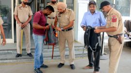 Security personnel check bags of workers before entering and after leaving EVM strongrooms in Patiala on Sunday. (Image: Harmeet Sodhi) punjab,