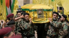 Hezbollah fighters carry the coffin of their comrade, senior commander Taleb Sami Abdullah, 55, known within Hezbollah as Hajj Abu Taleb, who was killed late Tusday by an Israeli strike in south Lebanon, during his funeral procession in the southern suburbs of Beirut, Lebanon, Wednesday, June 12, 2024. Hezbollah fired a massive barrage of rockets into northern Israel on Wednesday to avenge the killing of the top commander in the Lebanese militant group as the fate of an internationally-backed plan for a cease-fire in Gaza hung in the balance. (AP Photo/Bilal Hussein)
