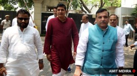 AAP leaders Sanjay Singh and Saurabh Bhardwaj with other party leaders outside Delhi Lieutenant Governor V K Saxena's residence on Sunday, for a meeting regarding the ongoing water crisis. (Express photo by Amit Mehra)