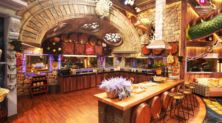 The kitchen is like a quaint vineyard, complete with stone walls and whimsical wine barrels, creating a cozy yet playful vibe.