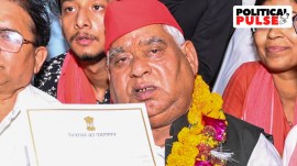 Samajwadi Party (SP) candidate from Faizabad constituency Awadhesh Prasad shows his certificate after winning the Lok Sabha elections, at Government Inter College, in Ayodhya, Tuesday, June 4, 2024. (PTI Photo)