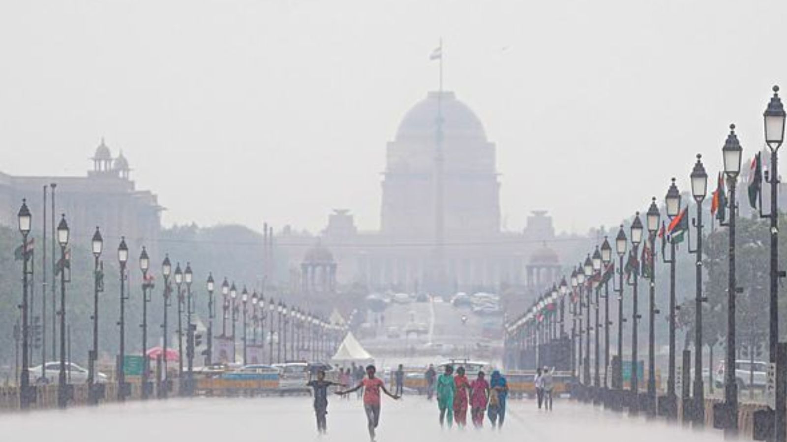 A group of visitors amid rain, at Kartavya Path in New Delhi