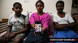 Daisy Manoj, sister of Denny Karunakaran, one of victims of the Kuwait fire incident, shows his picture, at her residence at Virar in Mumbai. (Express photo by Sankhadeep Banerjee)