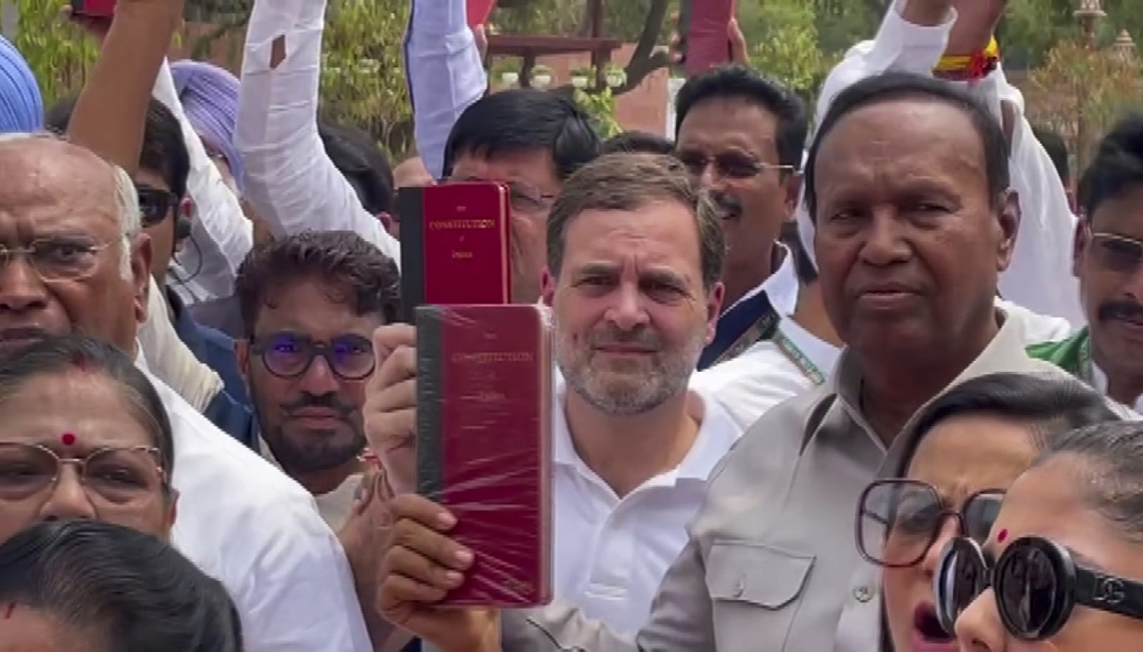 Congress leader Rahul Gandhi and other leaders of the INDIA bloc display copies of the Indian Constitution during their protest at the Parliament building on the first day of the first session of the 18th Lok Sabha. (PTI)