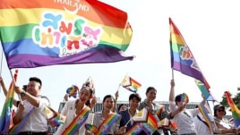 Members of the LGBTQ+ community hold flags that read "Marriage equality, love wins", as they celebrate the passing of the marriage equality bill in its second and third readings by the Senate, which will effectively make Thailand Asia's third territory to legalise same-sex unions. (Reuters photo)