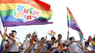 Members of the LGBTQ+ community hold flags that read "Marriage equality, love wins", as they celebrate the passing of the marriage equality bill in its second and third readings by the Senate, which will effectively make Thailand Asia's third territory to legalise same-sex unions. (Reuters photo)